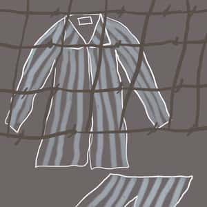 set of striped pajamas behind a barbed wire fence